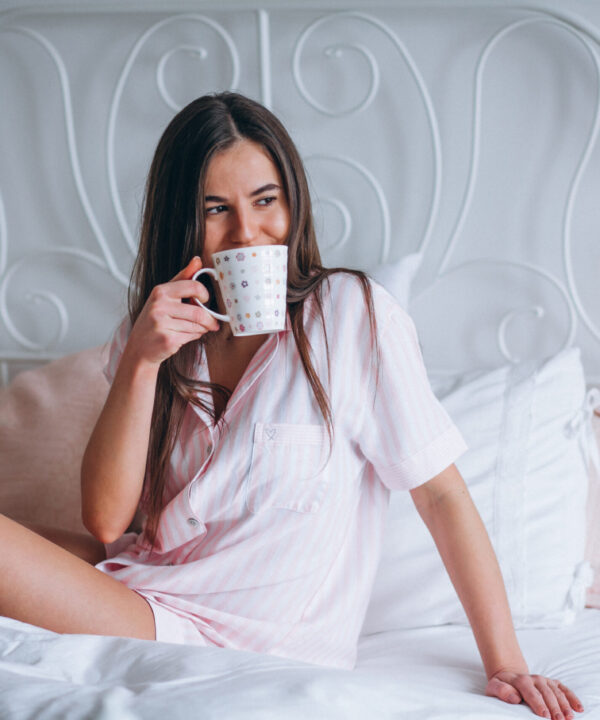 Woman drinking coffee in bed